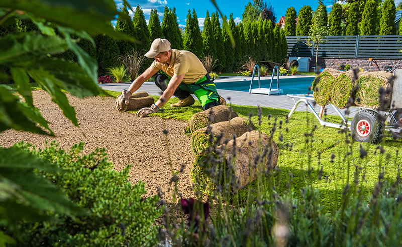 Springfield Gardens team planting flowers and maintaining a residential yard in Springfield, MO